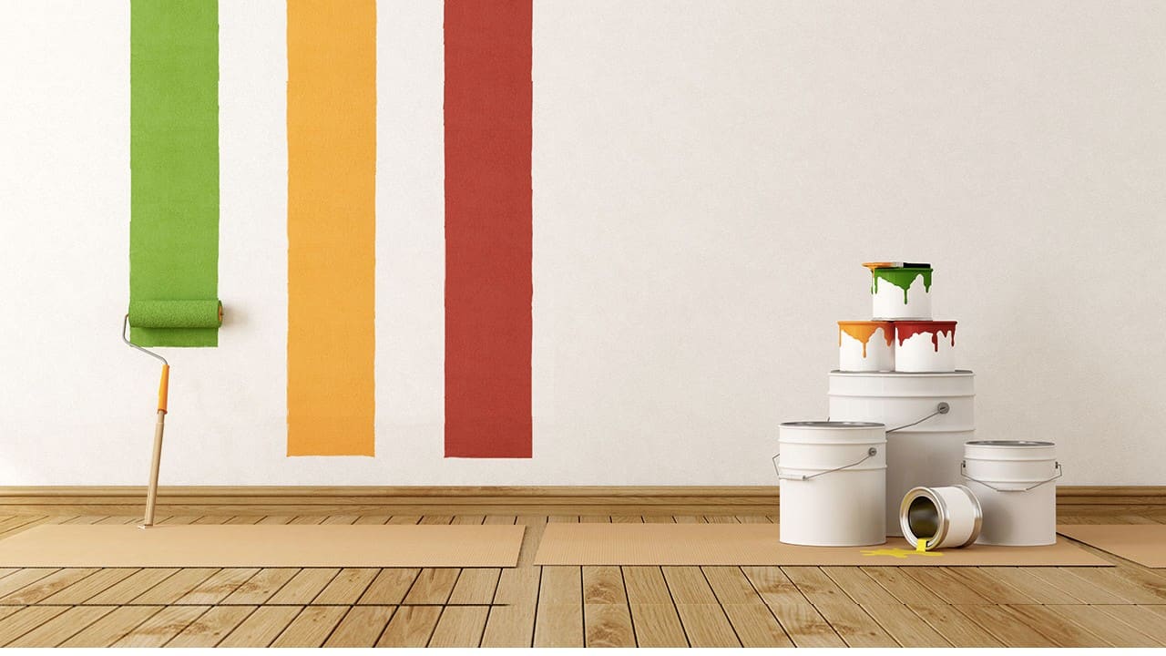 Paint roller and colourful paint stripes with paint tins — professional painters and decorators at Kings Renovations