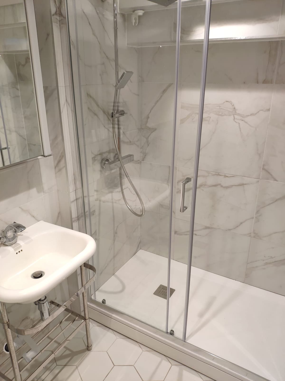 White marble tiled walk-in shower enclosure installation in Hertfordshire